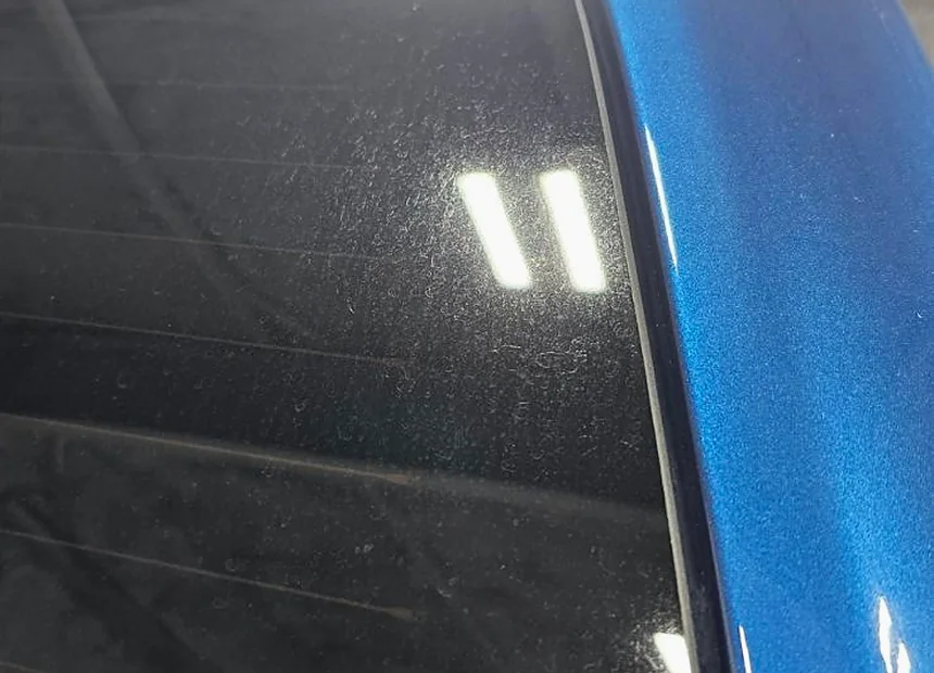 Hazed and lightly scratched glass picked out by the studio light bar