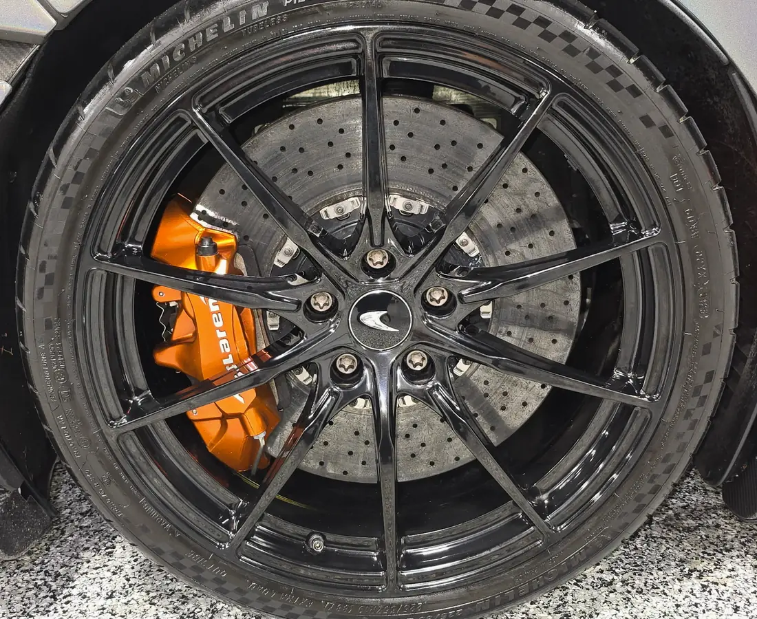 The same McLaren wheel and carbon ceramic brake cleaned, with the tire dressed