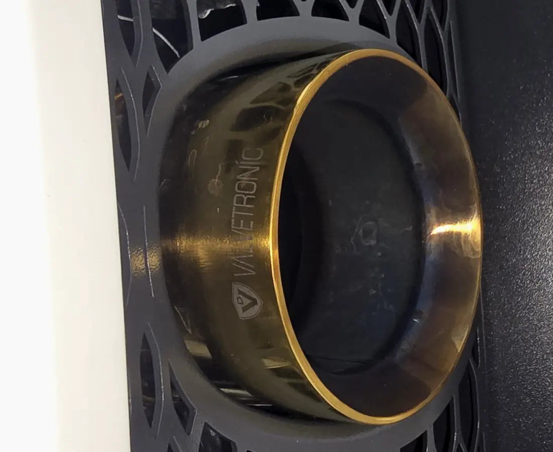A Valvetronic exhaust tip dulled by heat haze and road film before detailing