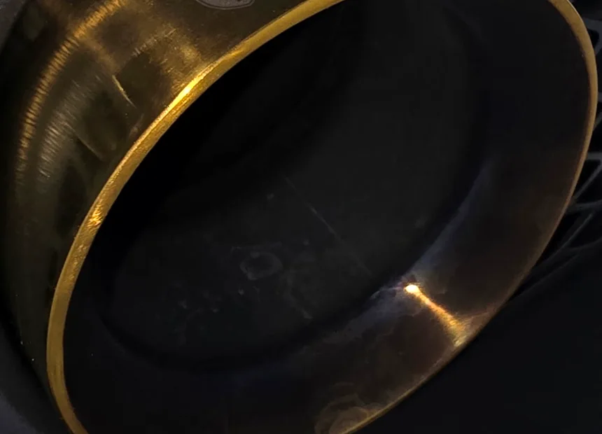 The face of a tarnished exhaust tip before polishing
