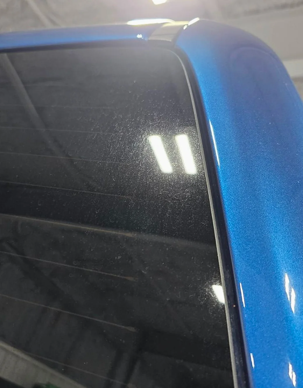 Hazed and etched rear quarter glass picked out by the studio light bar
