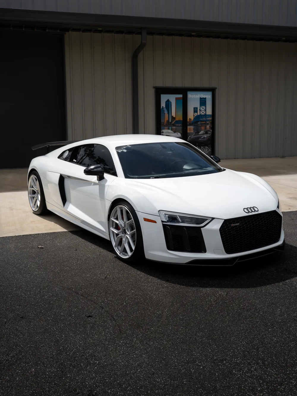 A white Audi R8 outside the Detail Geex studio after a detail