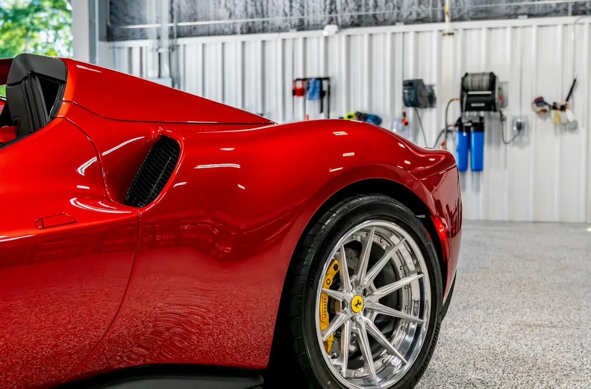 A red Ferrari inside the Detail Geex bay