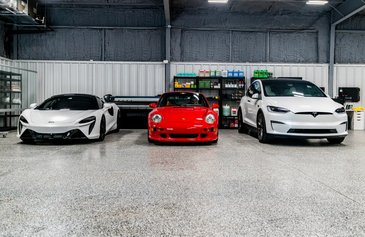 A McLaren, a Porsche and a Tesla lined up in the bay