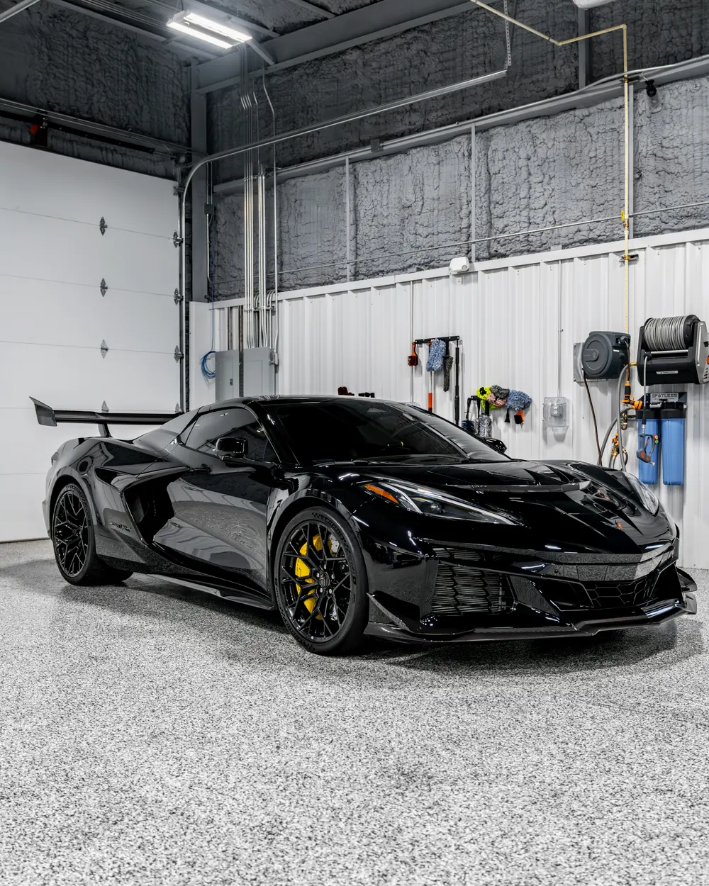 A black sports car with a satin finish in the bay