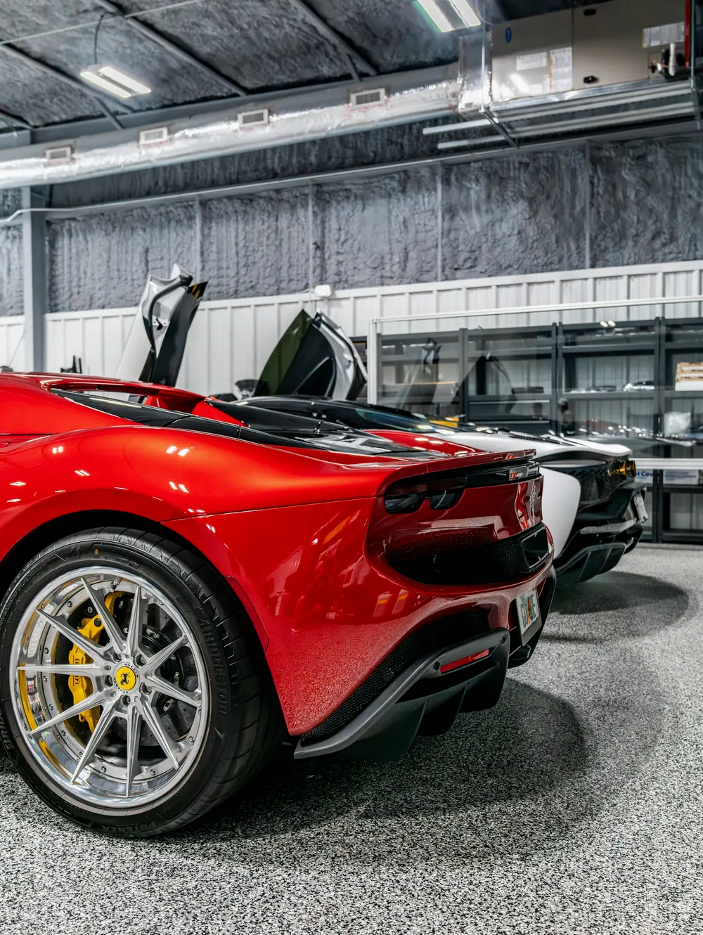 A red Ferrari with the roof down inside the studio
