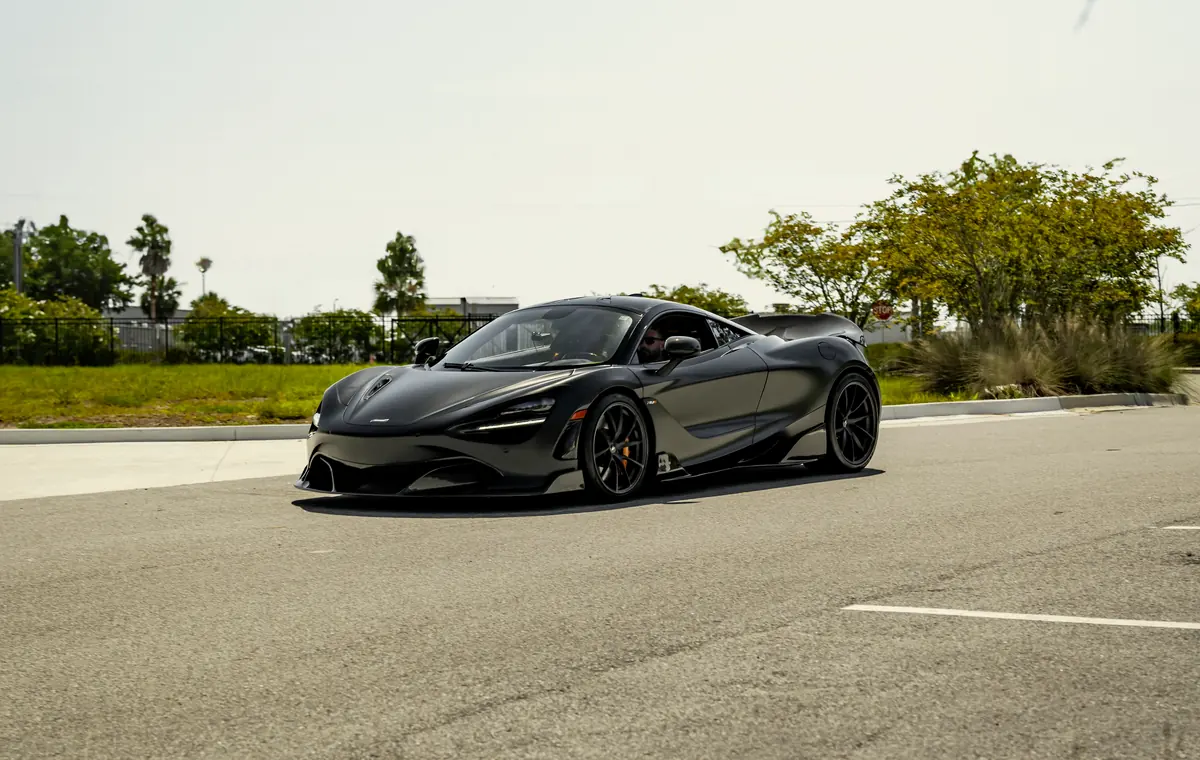 A dark McLaren photographed outdoors in Florida
