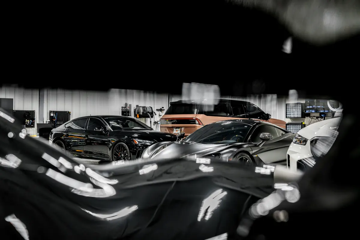 Reflections across a dark supercar in the studio