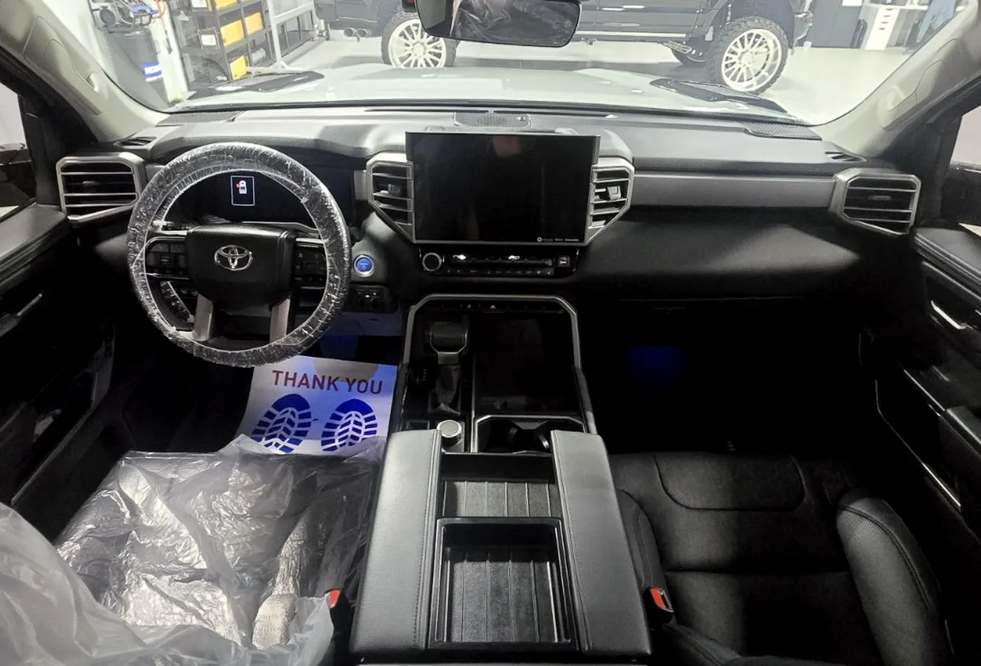 A cleaned truck cabin with the dash, console and seats detailed