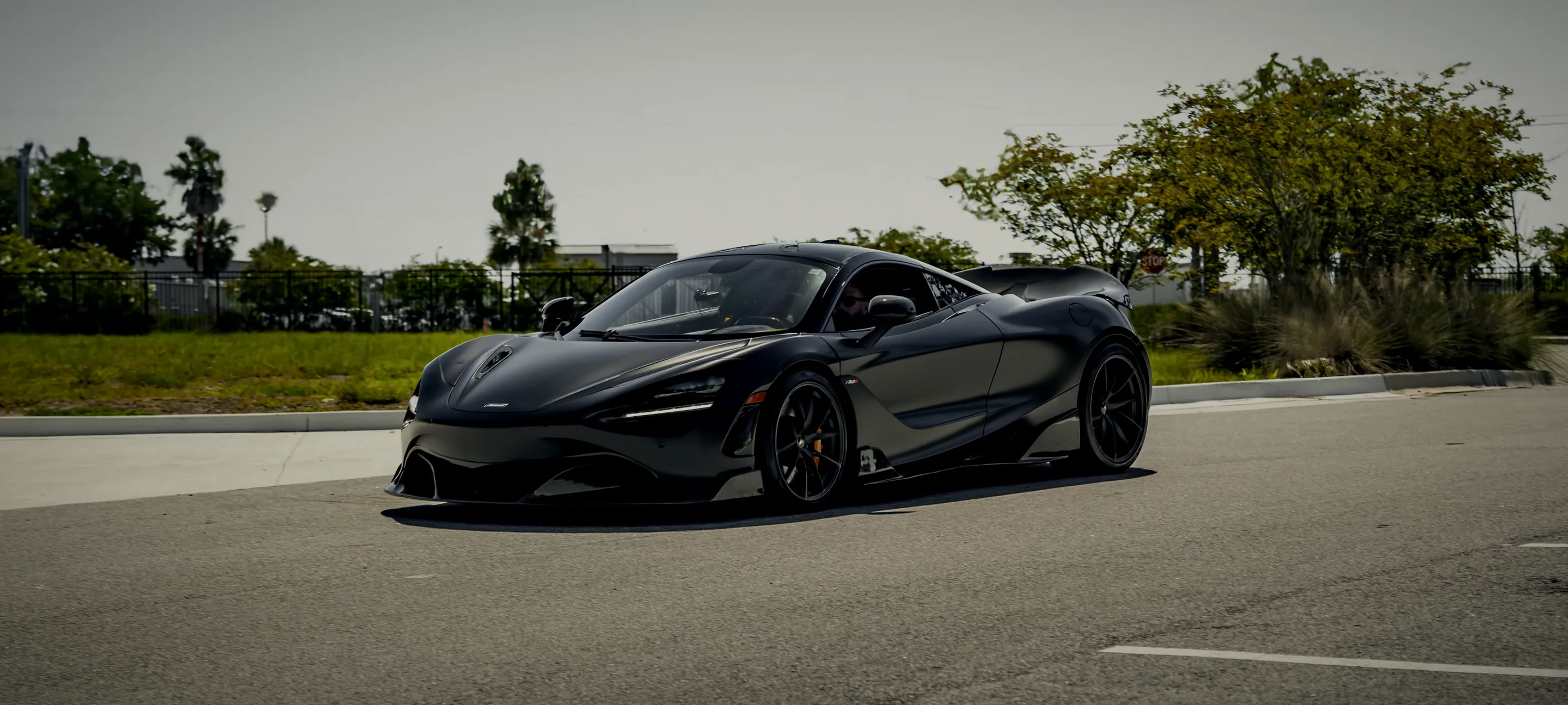 A dark McLaren on the road near the Detail Geex studio in Jacksonville