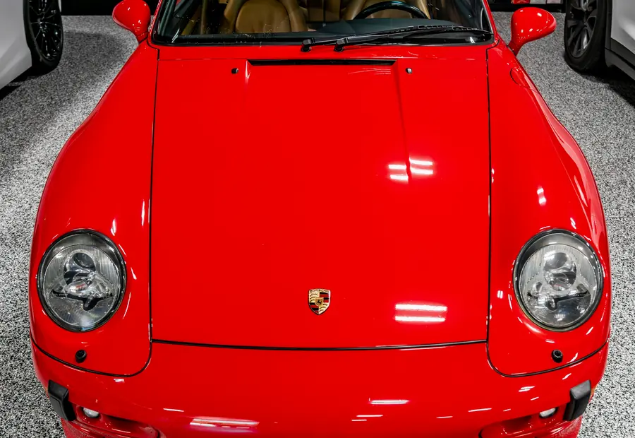 The headlights and front end of a red Porsche 911