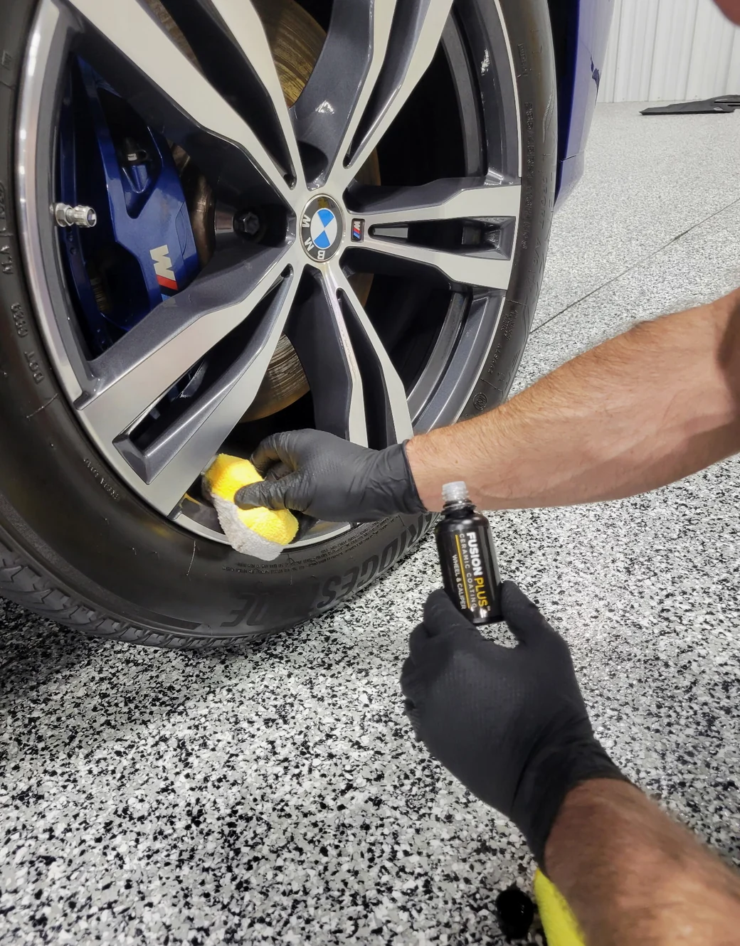 XPEL Fusion Plus wheel and caliper ceramic coating being applied by hand to a BMW M wheel at Detail Geex in Jacksonville